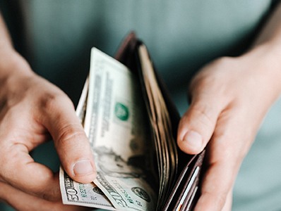 Man pulling cash out of wallet