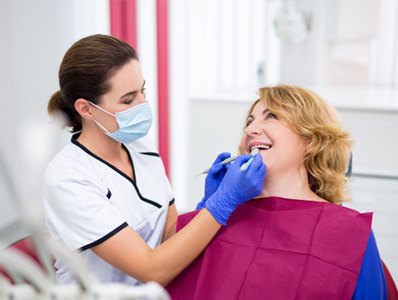 woman smiling while visiting dentist