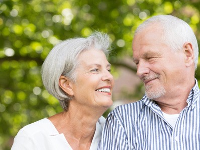 older couple smiling at each other  