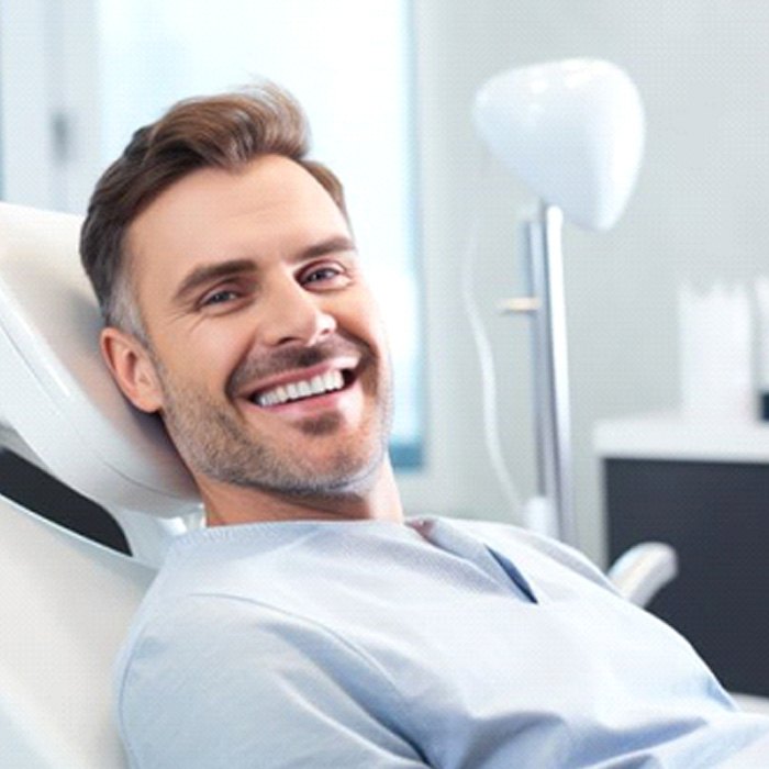 Smiling man in dental treatment chair