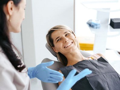 Happy patient speaking with dental team member