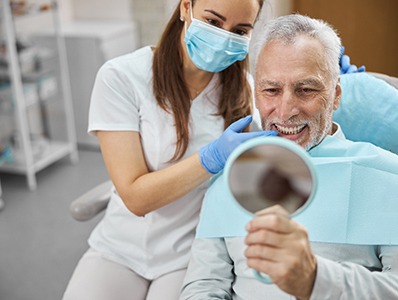 An elderly man enjoying his new dental implant