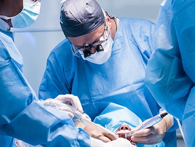 Dentists performing a dental implant surgery