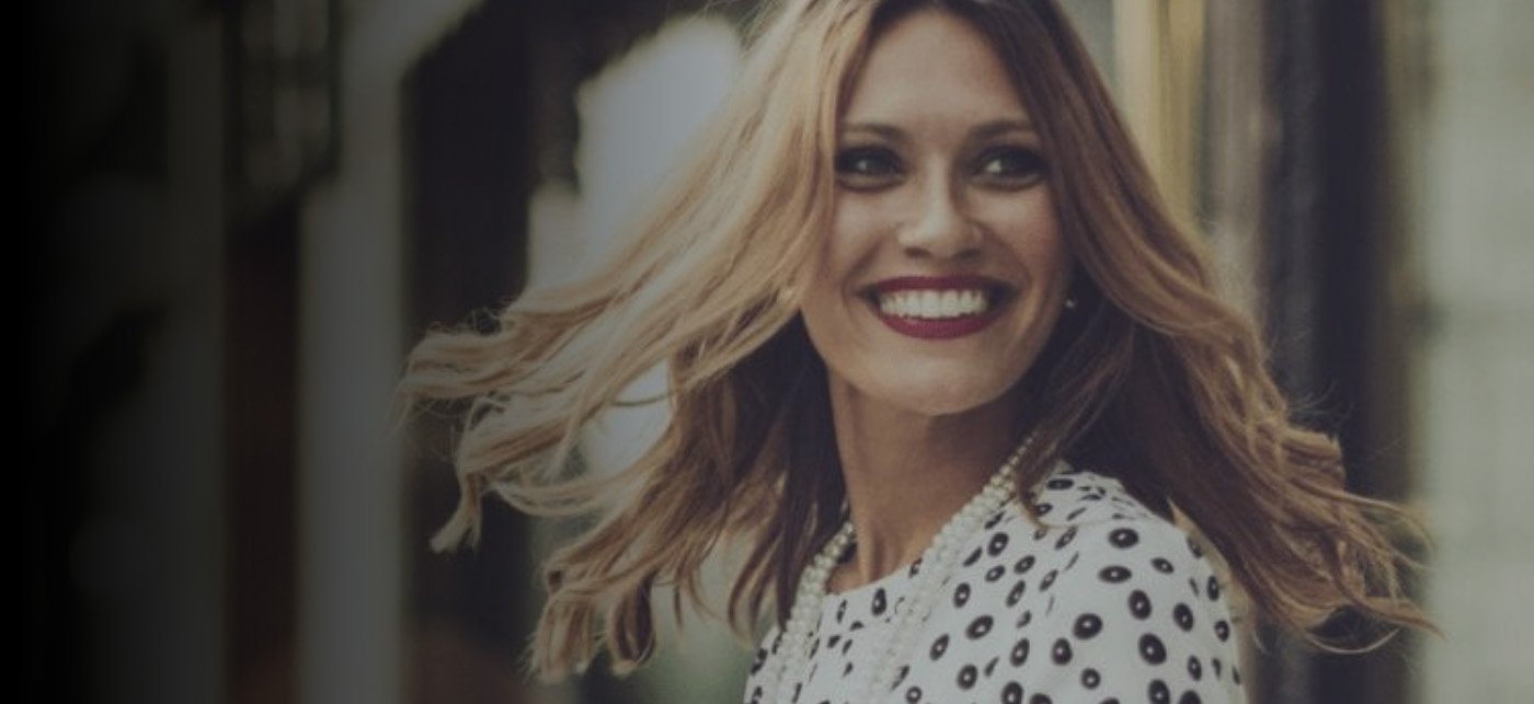 Woman smiling on a city street