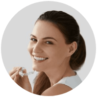 smiling woman holding invisalign
