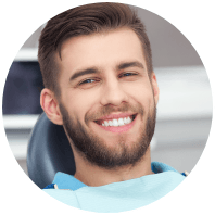 Smiling young man in dental chair