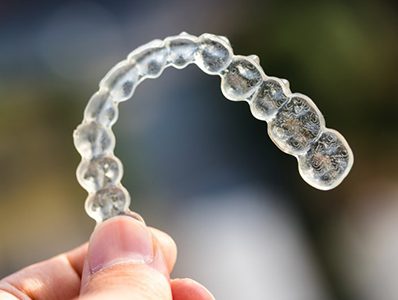 Closeup of Invisalign in Annandale on colorful background 
