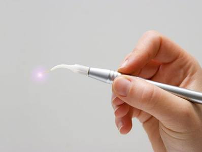 Hand holding laser dentistry tool