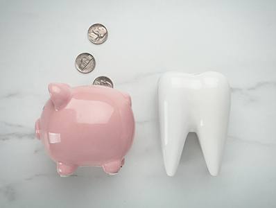 tooth and piggy bank for smile makeover in Annandale 
