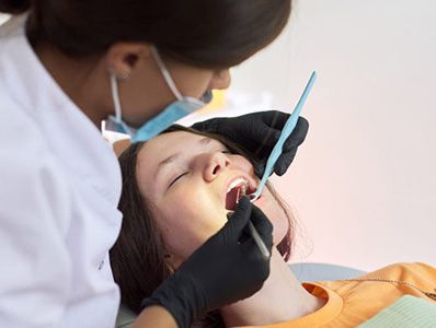 woman sedated and having teeth work done