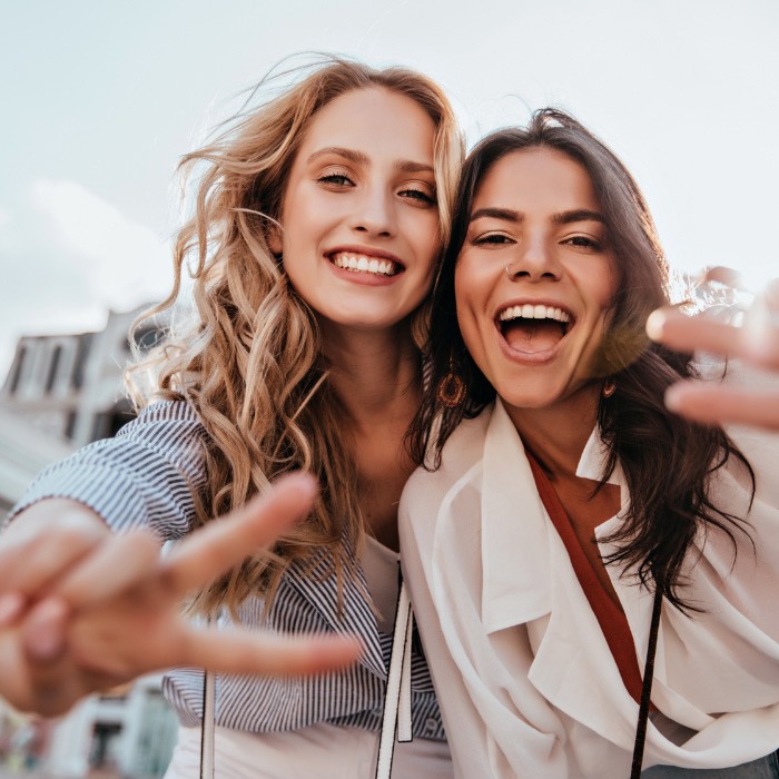 Two friends smiling after receiving exceptional dental services in Annandale Virginia