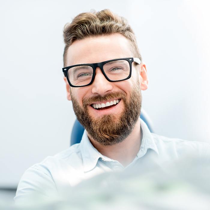 man smiling after getting veneers in Annandale