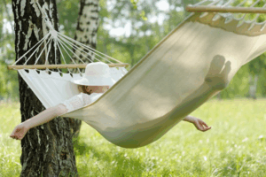 Adult relaxing in a hammock with their arms outstretched