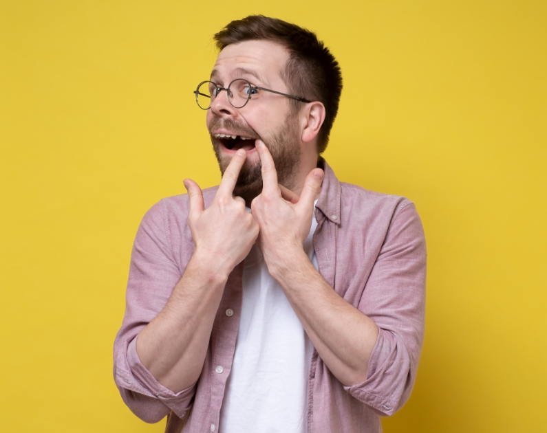 Man pointing at missing tooth