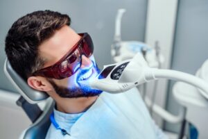 Patient having teeth whitened at dentist's office.