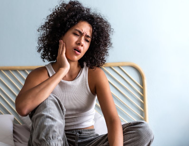 Woman holding jaw in pain